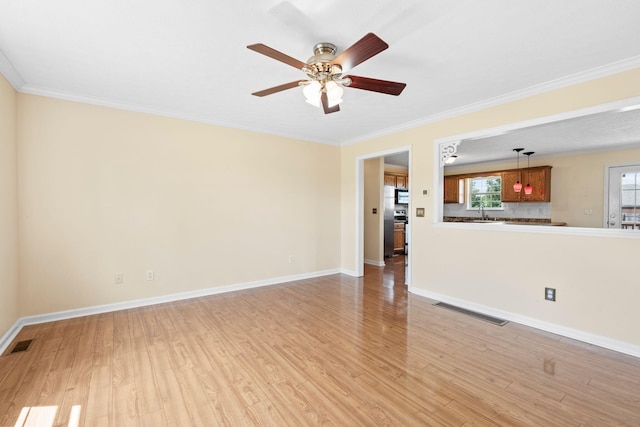 174 Shirdell Dr, Richmond, KY 40475 - unfurnished living room featuring light wood-style flooring, ornamental molding, a ceiling fan, a sink, and baseboards
