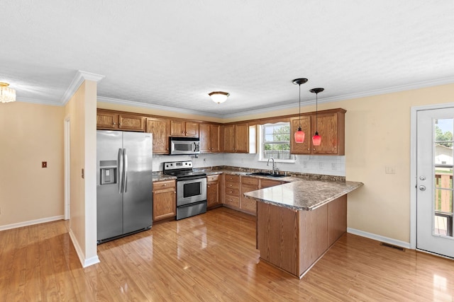 174 Shirdell Dr, Richmond, KY 40475 - kitchen with stainless steel appliances, a peninsula, brown cabinetry, a sink, and crown molding