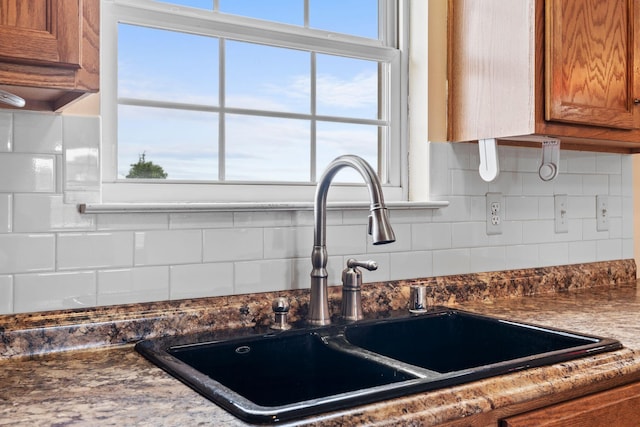 174 Shirdell Dr, Richmond, KY 40475 - kitchen with a sink, brown cabinetry, backsplash, and dark countertops