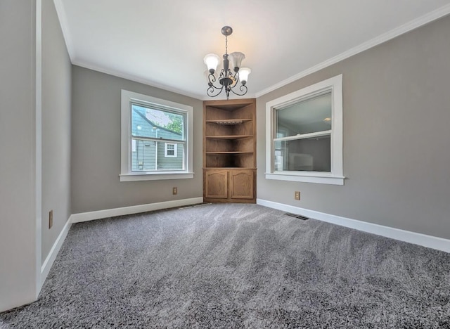 213 W Elm St, Nicholasville, KY 40356 - carpeted empty room with ornamental molding, a chandelier, baseboards, and built in shelves