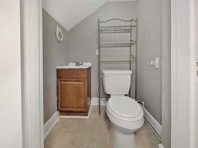 213 W Elm St, Nicholasville, KY 40356 - half bath with vaulted ceiling, toilet, vanity, baseboards, and tile patterned flooring