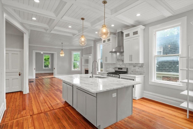 618 N Broadway, Lexington, KY 40508 - kitchen featuring wall chimney range hood, a sink, stainless steel gas range oven, light wood-style flooring, and coffered ceiling