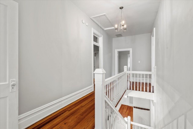 618 N Broadway, Lexington, KY 40508 - corridor with an upstairs landing, wood finished floors, attic access, and baseboards