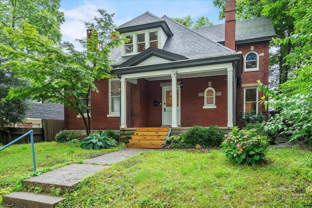 618 N Broadway, Lexington, KY 40508 - view of front of house with a chimney, brick siding, and covered porch