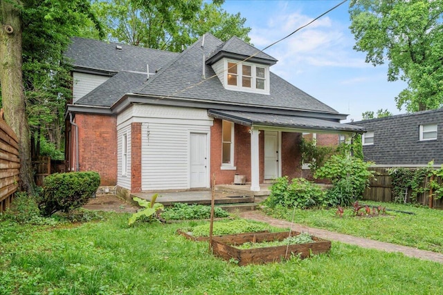 618 N Broadway, Lexington, KY 40508 - view of front of home with a shingled roof, brick siding, a garden, and covered porch