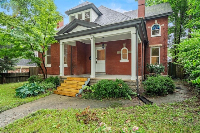 618 N Broadway, Lexington, KY 40508 - view of front of house with brick siding, covered porch, and a chimney