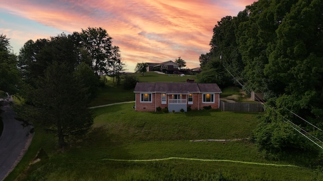 100 Mockingbird Hill Ln, Corbin, KY 40701 - back of property at dusk with brick siding and a chimney