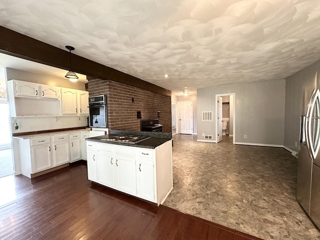 100 Mockingbird Hill Ln, Corbin, KY 40701 - kitchen featuring dark countertops, a center island, white cabinets, and appliances with stainless steel finishes