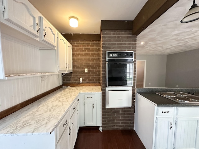 100 Mockingbird Hill Ln, Corbin, KY 40701 - kitchen with oven, stainless steel gas stovetop, white cabinetry, dark wood finished floors, and light stone countertops