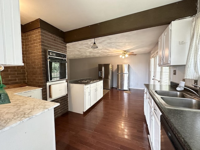 100 Mockingbird Hill Ln, Corbin, KY 40701 - kitchen with stainless steel appliances, a sink, dark wood-style floors, white cabinets, and a warming drawer