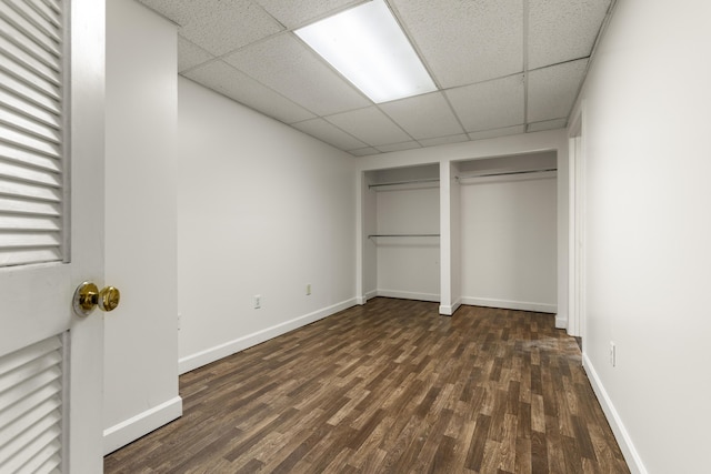816 Stratton Ln, Winchester, KY 40391 - unfurnished bedroom featuring dark wood-type flooring, a drop ceiling, baseboards, and two closets