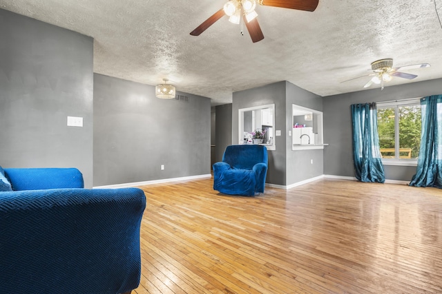 816 Stratton Ln, Winchester, KY 40391 - sitting room featuring ceiling fan, wood-type flooring, baseboards, and a textured ceiling