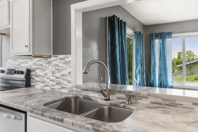 816 Stratton Ln, Winchester, KY 40391 - kitchen with a sink, backsplash, appliances with stainless steel finishes, white cabinetry, and light stone counters