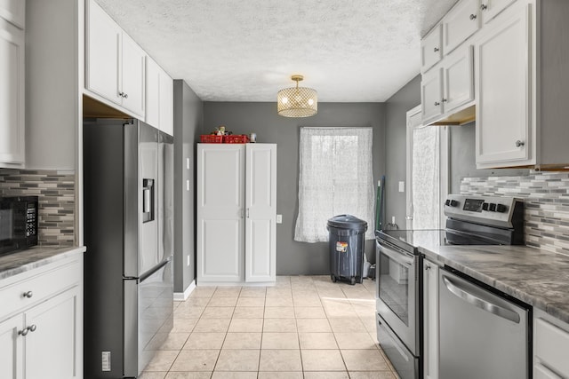 816 Stratton Ln, Winchester, KY 40391 - kitchen with appliances with stainless steel finishes, tasteful backsplash, light tile patterned floors, white cabinets, and a textured ceiling