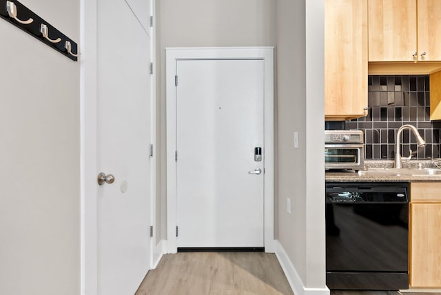 250 S Martin Luther King Blvd Unit 311, Lexington, KY 40508 - kitchen featuring black dishwasher, light brown cabinets, backsplash, light wood-type flooring, and light stone countertops