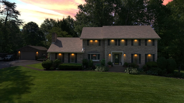153 Pine Trail Rd, London, KY 40744 - colonial home featuring a chimney, a front lawn, stone siding, a garage, and a shingled roof