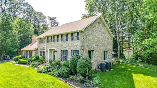 153 Pine Trail Rd, London, KY 40744 - colonial home featuring a front lawn, a chimney, brick siding, and an outbuilding