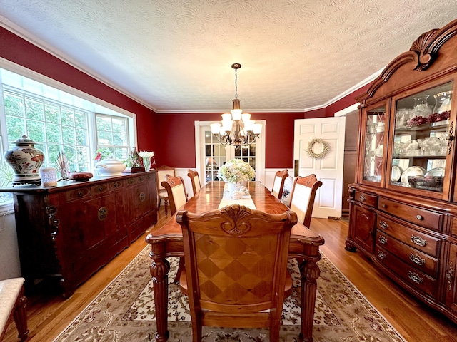 153 Pine Trail Rd, London, KY 40744 - dining space with a chandelier, wood finished floors, wainscoting, a textured ceiling, and ornamental molding