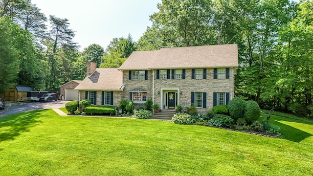153 Pine Trail Rd, London, KY 40744 - colonial home featuring a chimney, a front lawn, driveway, and a garage