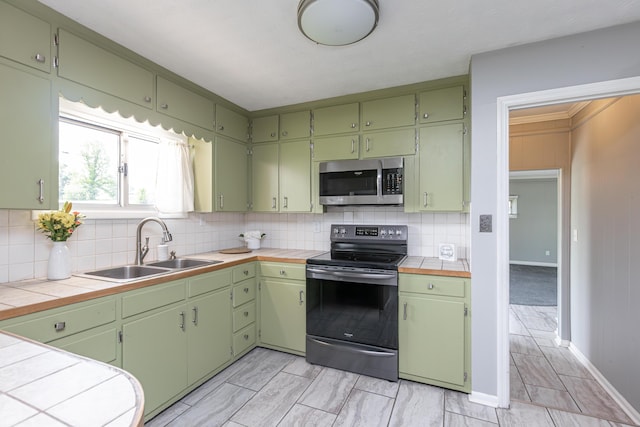 9581 Harrodsburg Rd, Wilmore, KY 40390 - kitchen with range with electric cooktop, stainless steel microwave, tile counters, and backsplash