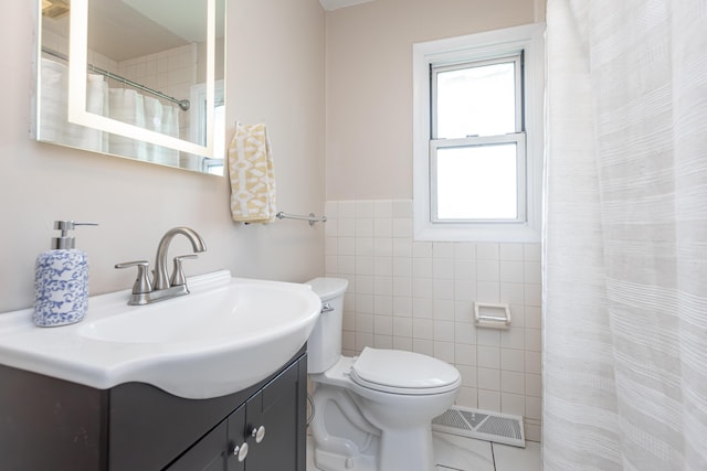 9581 Harrodsburg Rd, Wilmore, KY 40390 - full bathroom with tile walls, vanity, tile patterned flooring, curtained shower, and a wainscoted wall