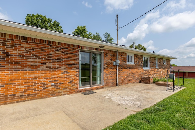 9581 Harrodsburg Rd, Wilmore, KY 40390 - rear view of house featuring a patio area, brick siding, and a yard