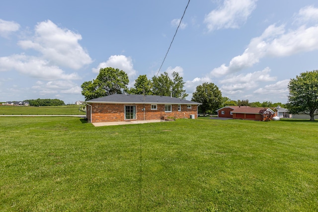 9581 Harrodsburg Rd, Wilmore, KY 40390 - rear view of house with a lawn, brick siding, and a patio area