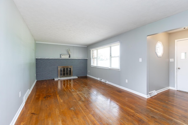 9581 Harrodsburg Rd, Wilmore, KY 40390 - unfurnished living room featuring hardwood / wood-style floors and a brick fireplace