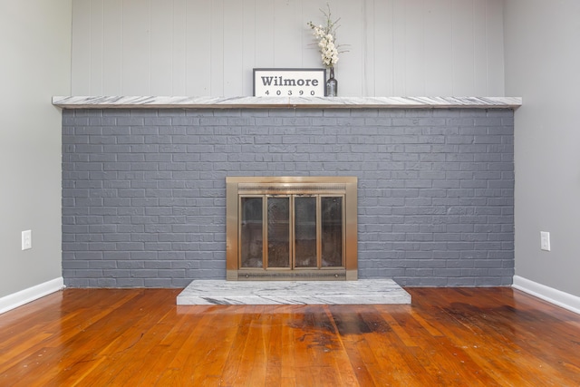 9581 Harrodsburg Rd, Wilmore, KY 40390 - detailed view of a brick fireplace and wood finished floors