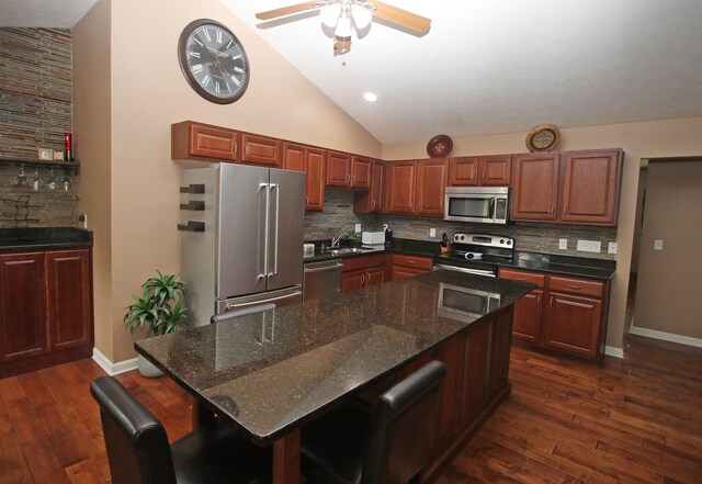 5420 Kiddville Ln, Lexington, KY 40515 - kitchen with stainless steel appliances, decorative backsplash, lofted ceiling, dark wood-type flooring, and ceiling fan
