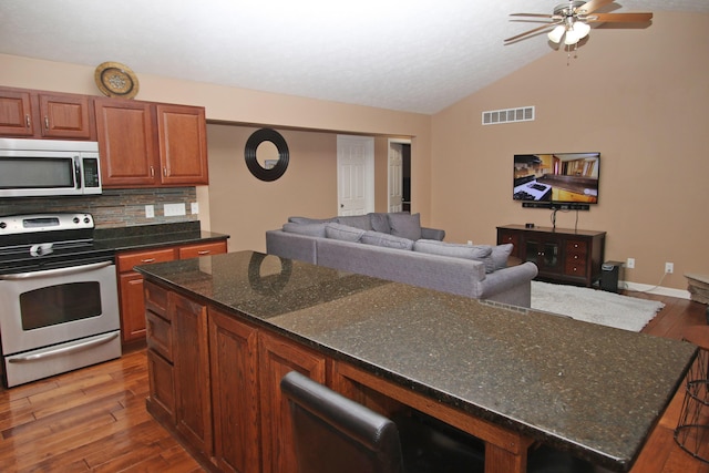5420 Kiddville Ln, Lexington, KY 40515 - kitchen with appliances with stainless steel finishes, vaulted ceiling, wood-type flooring, ceiling fan, and tasteful backsplash