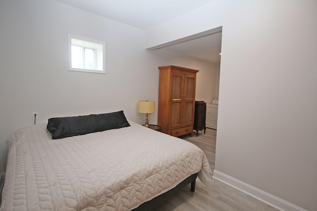 5420 Kiddville Ln, Lexington, KY 40515 - bedroom with light wood-type flooring, baseboards, and washer / dryer