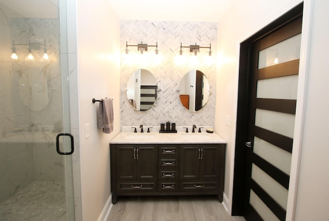 5420 Kiddville Ln, Lexington, KY 40515 - full bathroom with double vanity, a marble finish shower, wood finished floors, and baseboards