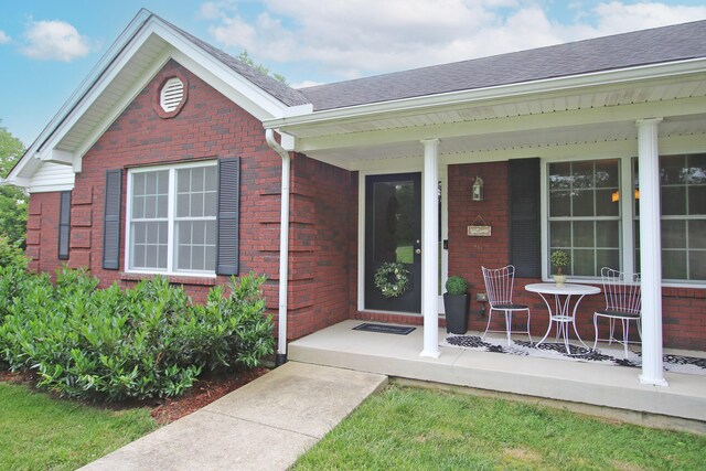 5420 Kiddville Ln, Lexington, KY 40515 - doorway to property with brick siding, a porch, and roof with shingles