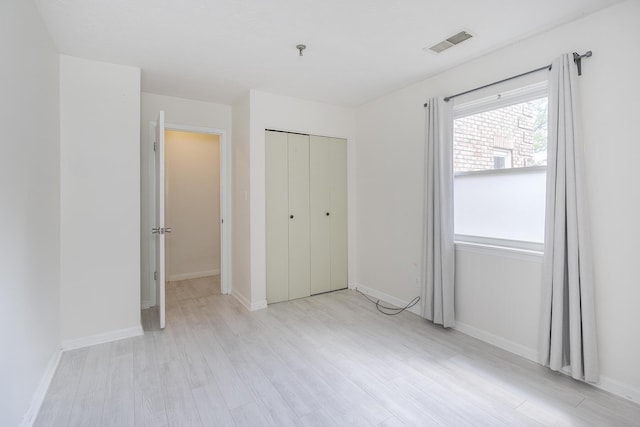 421 Redding Rd Unit 56, Lexington, KY 40517 - unfurnished bedroom featuring light wood-style flooring, a closet, and baseboards