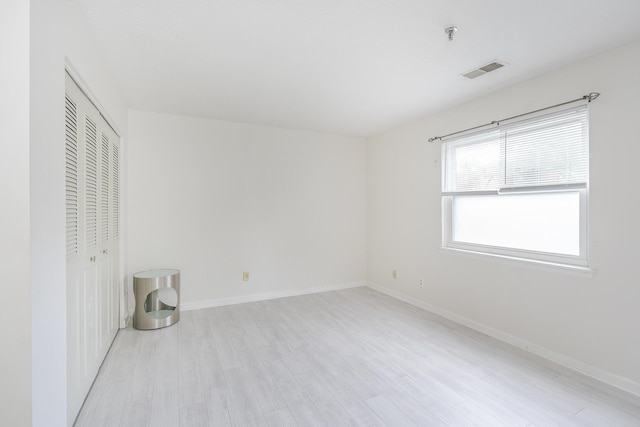 421 Redding Rd Unit 56, Lexington, KY 40517 - unfurnished bedroom featuring light wood-style flooring, a closet, and baseboards