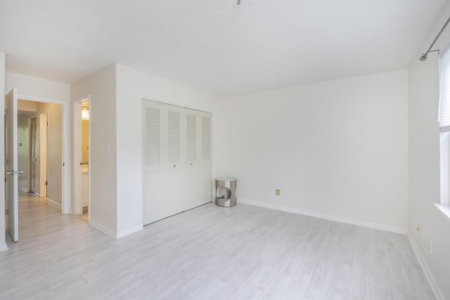 421 Redding Rd Unit 56, Lexington, KY 40517 - unfurnished bedroom featuring light wood-type flooring, a closet, and baseboards