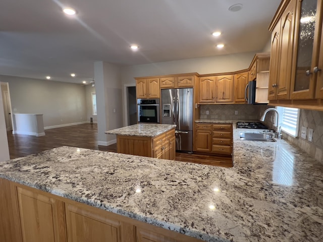 131 Betsy Ross Ln, Danville, KY 40422 - kitchen with stainless steel appliances, a sink, decorative backsplash, light stone counters, and glass insert cabinets