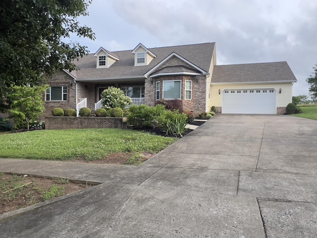 131 Betsy Ross Ln, Danville, KY 40422 - new england style home with driveway, an attached garage, a front lawn, roof with shingles, and brick siding