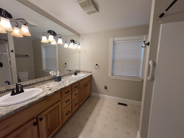 131 Betsy Ross Ln, Danville, KY 40422 - bathroom featuring double vanity, baseboards, toilet, and a shower