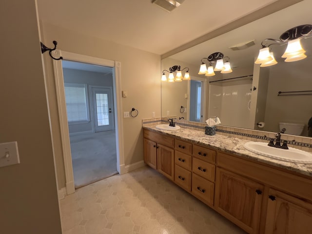 131 Betsy Ross Ln, Danville, KY 40422 - full bath featuring double vanity, a shower, toilet, a chandelier, and baseboards