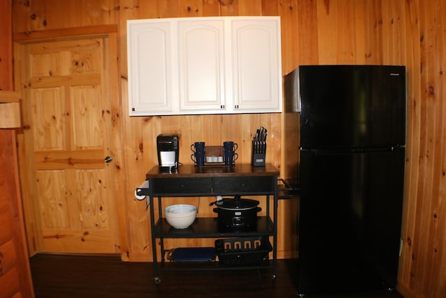 16 Hardwood Hl, Salt Lick, KY 40371 - kitchen featuring freestanding refrigerator, wooden walls, dark countertops, and white cabinetry