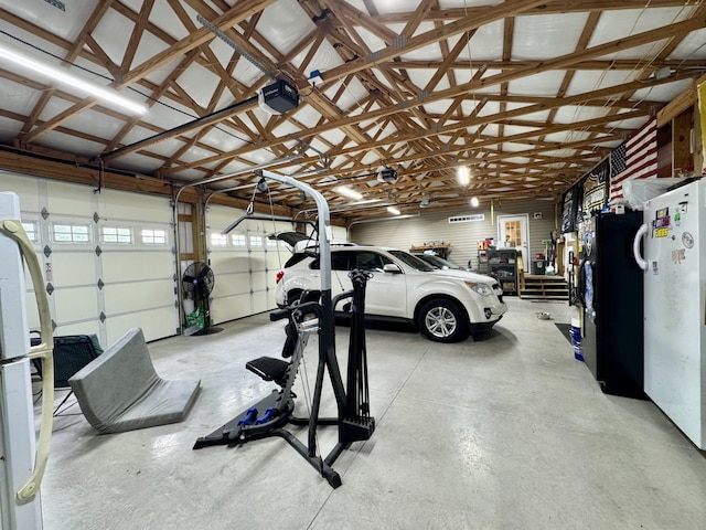 115 Wolf Creek Crossing Rd, Nancy, KY 42544 - garage with a garage door opener and freestanding refrigerator