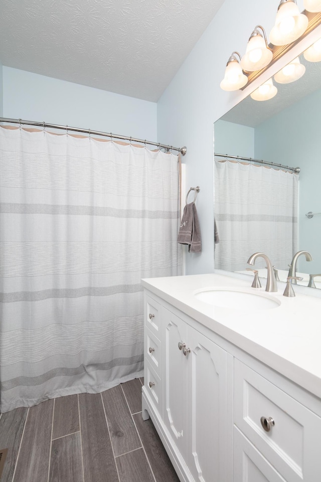 3008 Roundway Down Ln, Lexington, KY 40509 - full bath featuring vanity, wood tiled floors, and a textured ceiling