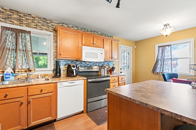 1716 Biloxi Ct, Lexington, KY 40505 - kitchen featuring white appliances, a sink, light wood-style flooring, backsplash, and brown cabinets