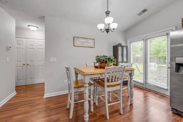 1416 Equine Way, Frankfort, KY 40601 - dining area with wood finished floors, baseboards, a chandelier, and a textured ceiling