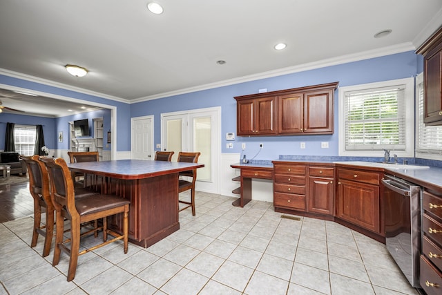 1369 Saddle Club Way, Lexington, KY 40504 - kitchen with stainless steel dishwasher, a sink, crown molding, wainscoting, and light tile patterned floors