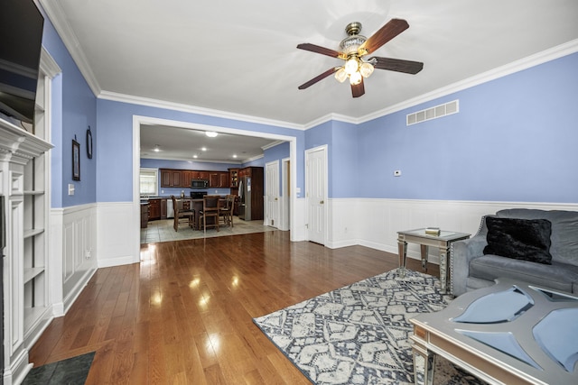 1369 Saddle Club Way, Lexington, KY 40504 - living area with ceiling fan, ornamental molding, wainscoting, and dark wood-style floors