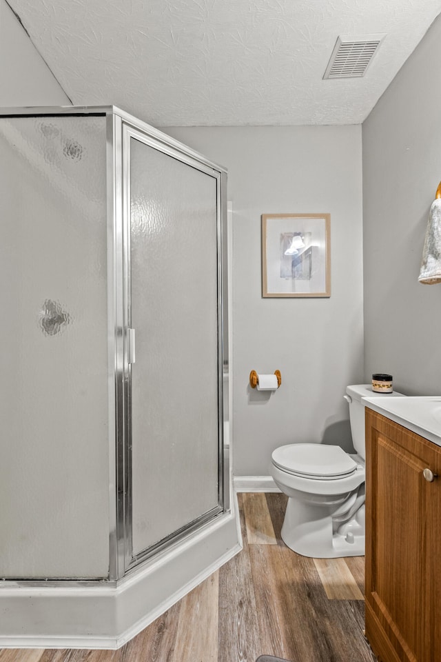 416 Scottsdale Cir, Lexington, KY 40511 - bathroom featuring wood finished floors, a stall shower, vanity, and a textured ceiling