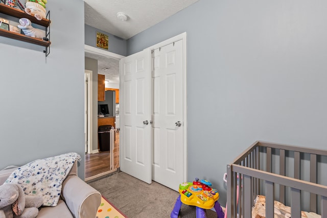 416 Scottsdale Cir, Lexington, KY 40511 - carpeted bedroom featuring a textured ceiling and a crib
